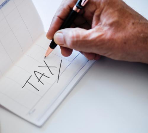 Check book with "Tax" written on it