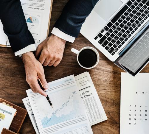 Business Person pointing at Analysis sheet 