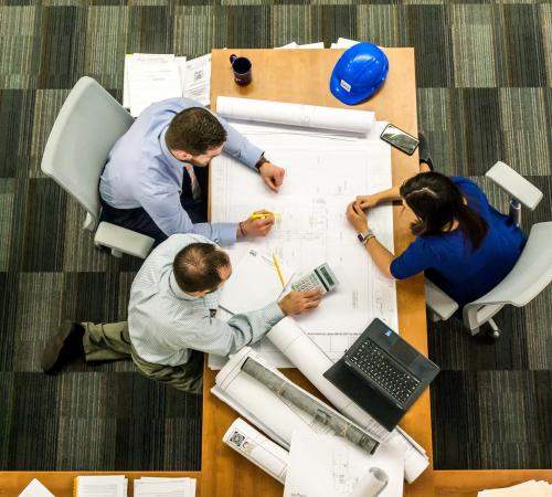 Adults working at conference room table
