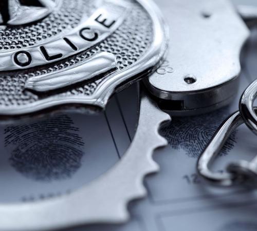 badge handcuffs and fingerprint