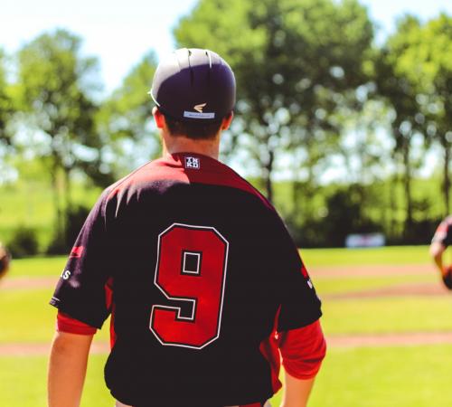 Adult in baseball shirt in park