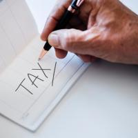 Check book with "Tax" written on it