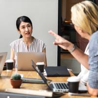 Business Woman Instructing Other Business Woman