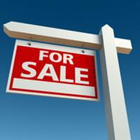 for sale sign in front of blue sky