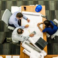 Adults working at conference room table