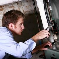 person working on heating and cooling system