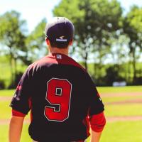 Adult in baseball shirt in park