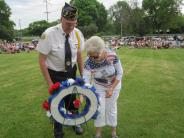 Karen Grant placing flower wreath