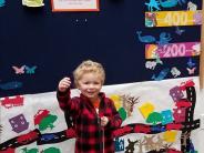 Child celebrating 1000 books achievement