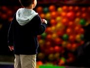 Boy next to carnival game