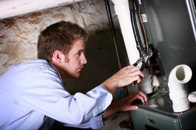person working on heating and cooling system